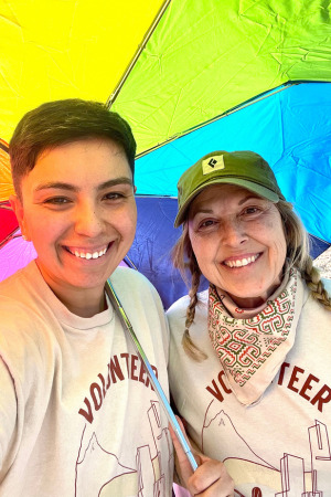 Avid & Carleen smiling under a rainbow umbrella at La Mar Park.